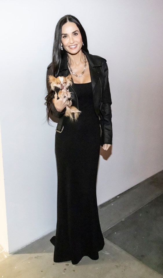 Demi Moore beams on a film festival red carpet with her pet pooch, Pilaf