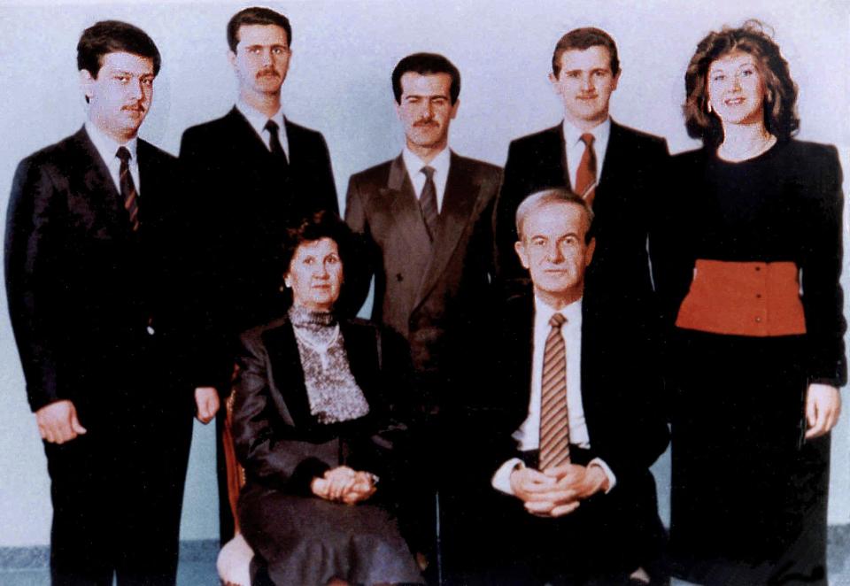 The young Assad brothers (pictured first and second from top left) with their parents and siblings