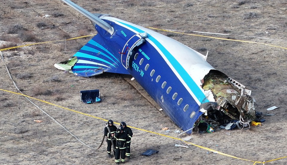 A drone view shows emergency specialists working at the crash site