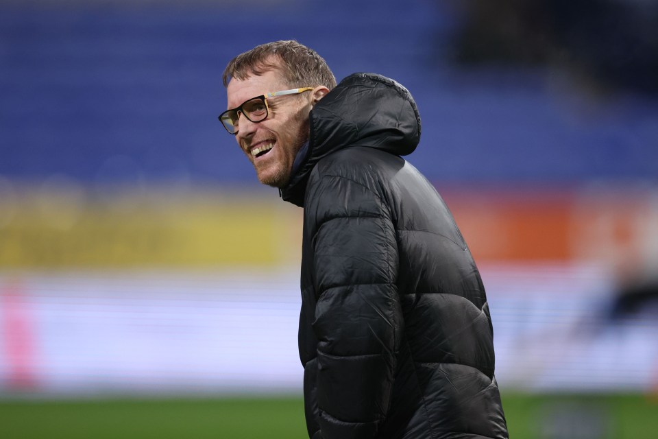 Brett Ormerod, assistant manager, smiling at a football match.