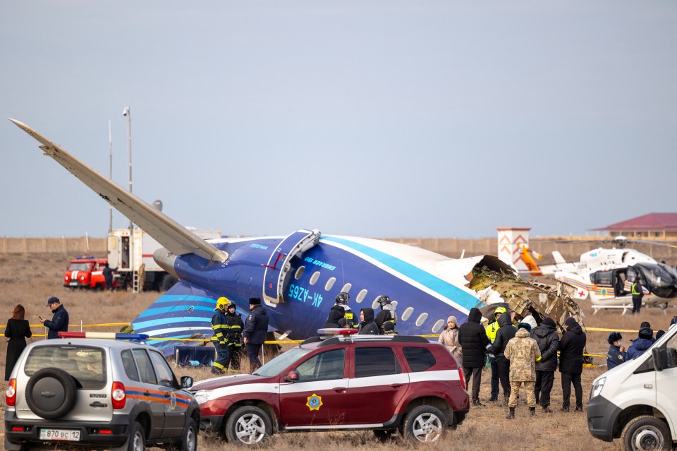 Emergency personnel at the crash site of an Azerbaijan Airlines passenger jet.