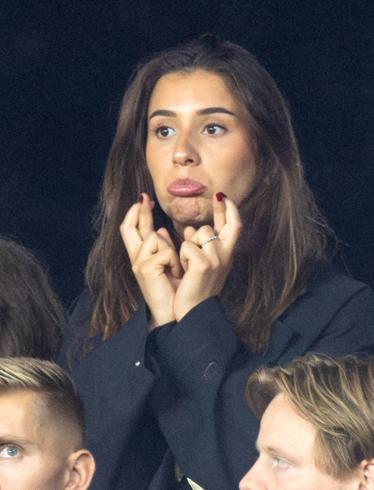 Erling Haaland's girlfriend, Isabel Haugseng Johansen, with hands clasped, watching a Norway soccer game.