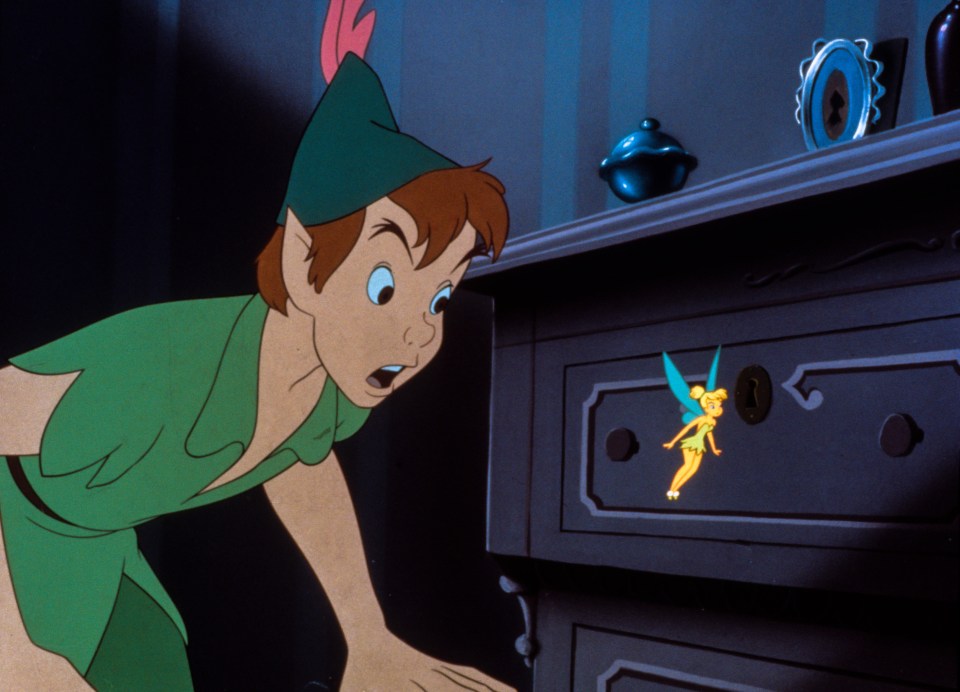 Peter Pan looking at Tinkerbell on a dresser.