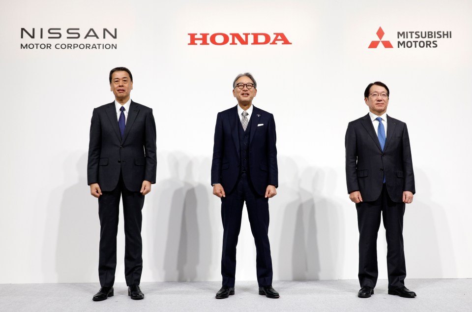 Nissan Motor Co. President and CEO Makoto Uchida, Honda Motor Co. President Toshihiro Mibe, and Mitsubishi Motors Corp. President and CEO Takao Kato at a press conference yesterday