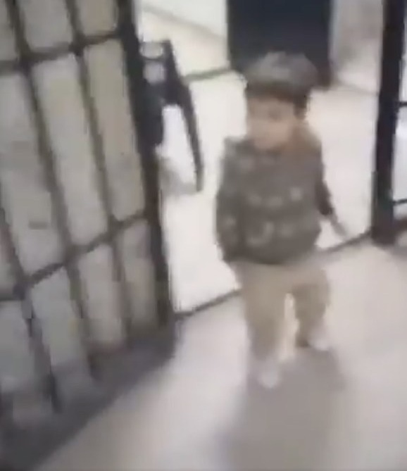 A little boy is seen leaving his cell in Syria’s infamous Saydnaya military prison