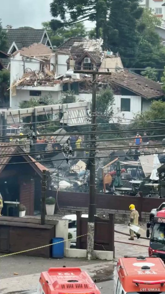 Firefighters work at the scene of damaged buildings