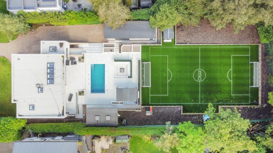 The house comes with a swimming pool and its own football pitch - with JM10 etched into the middle