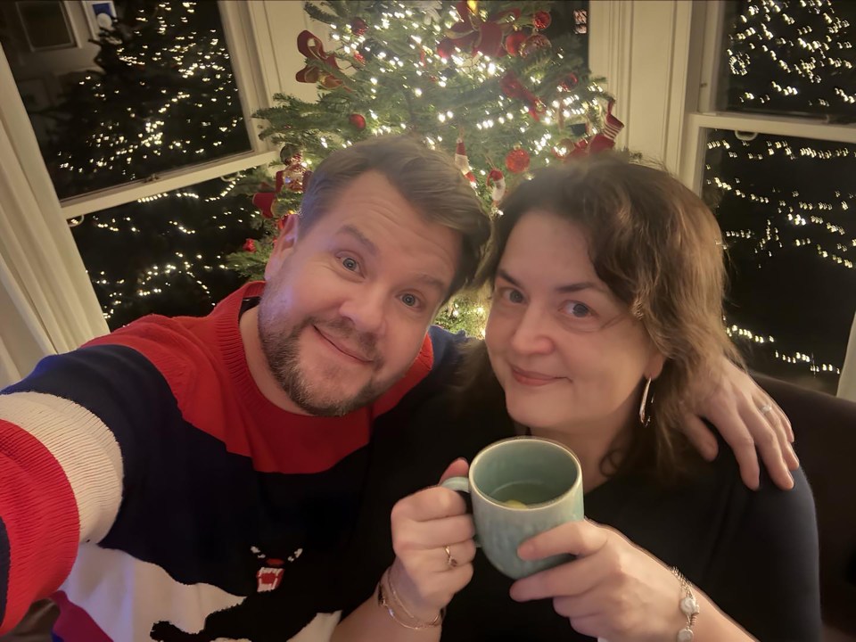 James Corden and Ruth Jones in front of a Christmas tree.