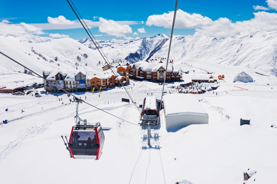 Gondola lift at a snowy ski resort.