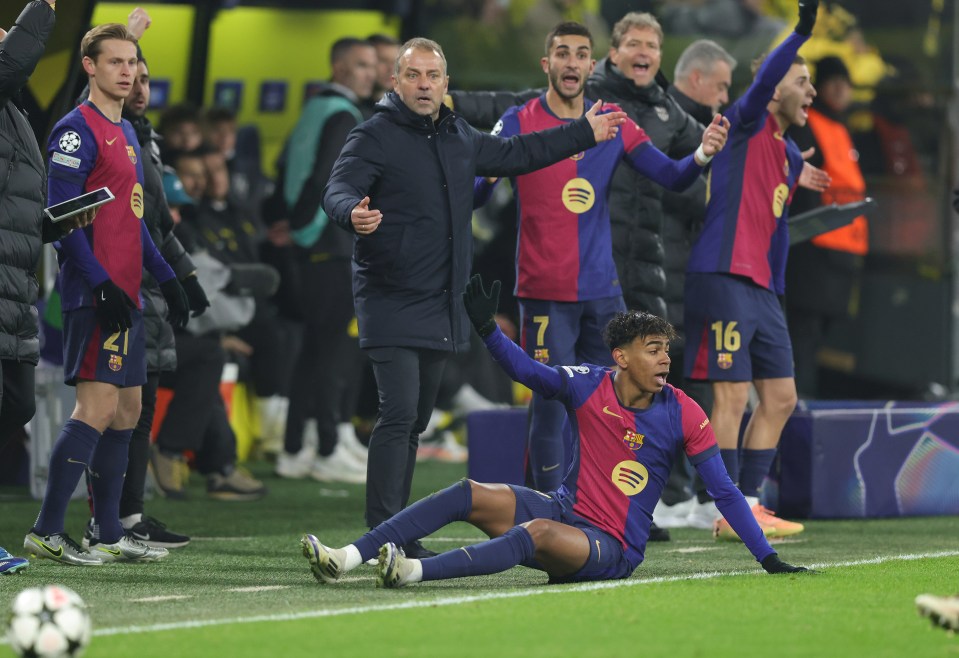 Hansi Flick, Barcelona's head coach, reacts as a player sits on the field.