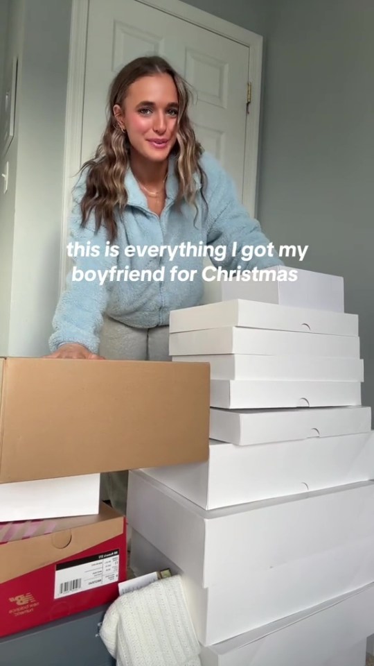 Woman showing many Christmas gifts for her boyfriend.