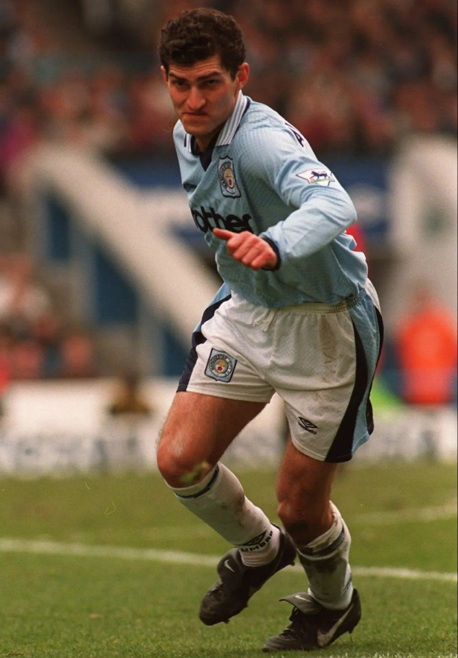 Manchester City footballer running with the ball.