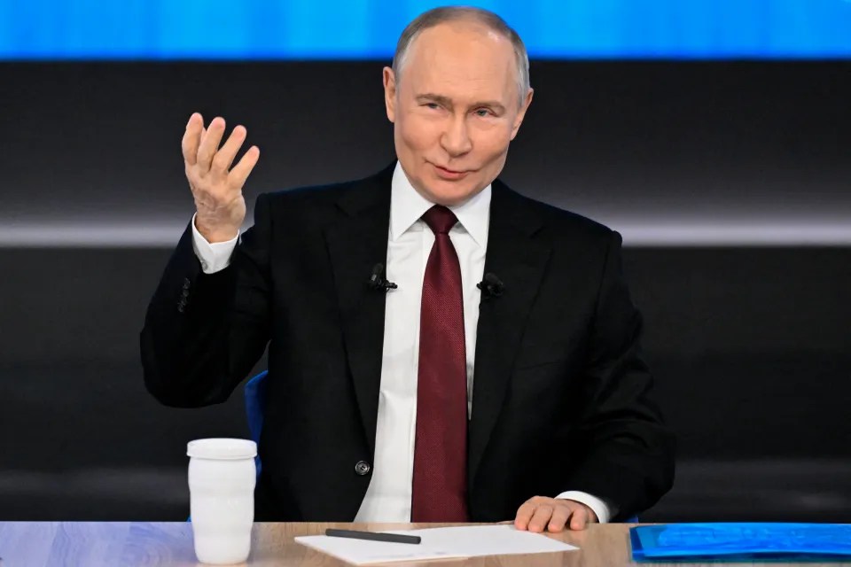 Vladimir Putin gesturing during an interview.