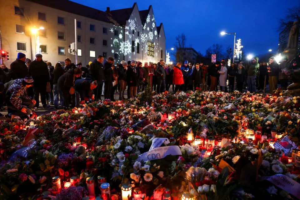 Hundreds gather around a makeshift mural near to where the tragedy took place