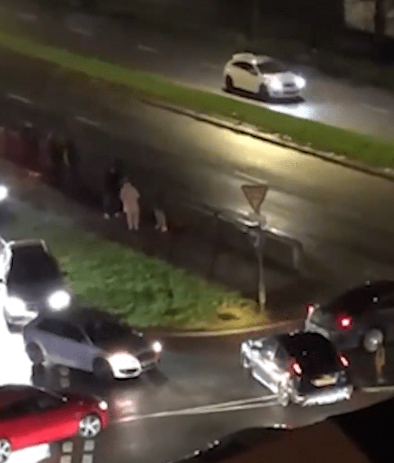 People gathered at the side of the road to watch