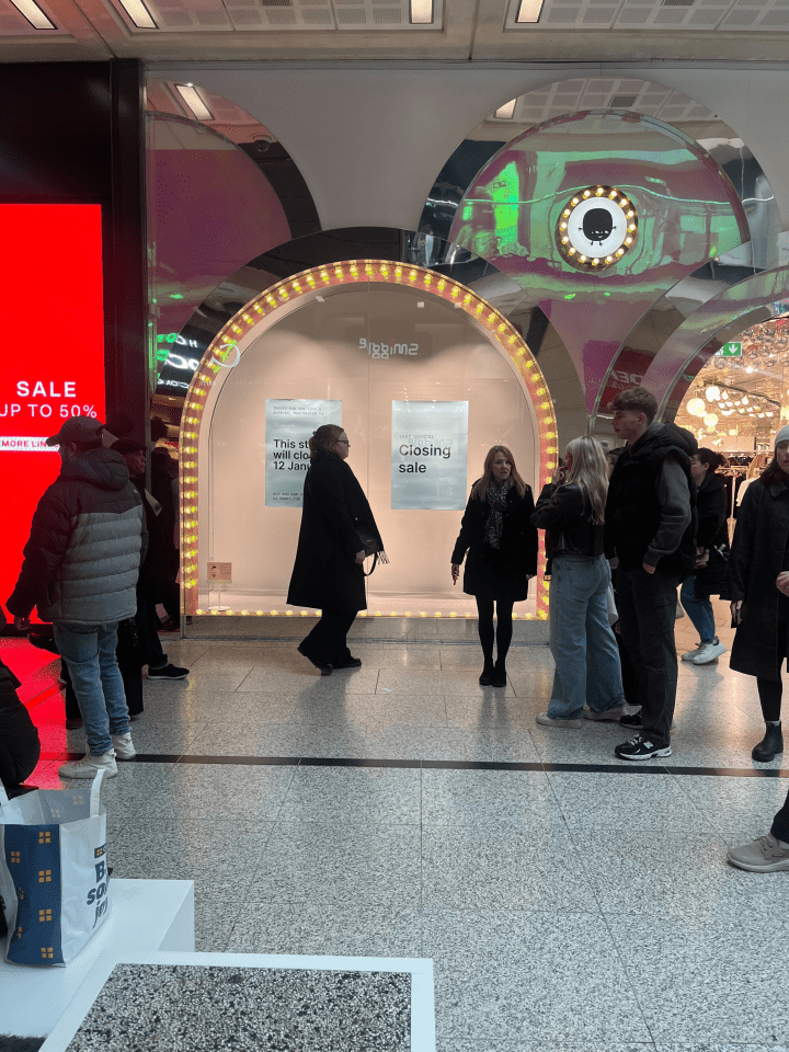 Queue of people outside a closing sale at a Biggin2 store.