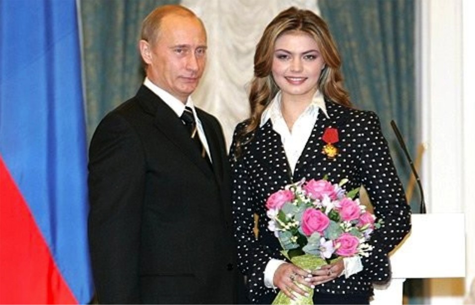 Vladimir Putin presenting an award to a woman.