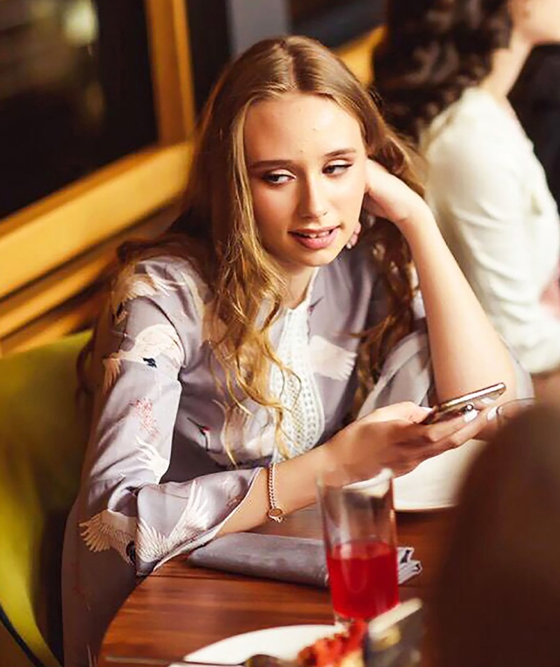 Woman looking at her phone at a restaurant.