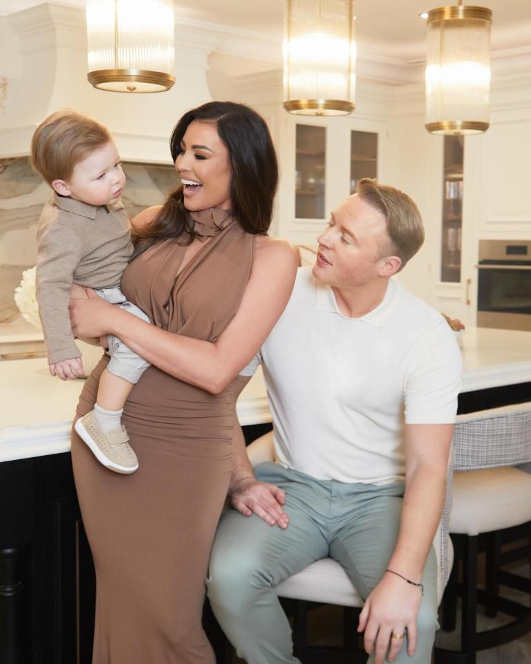 Jess Wright, her husband, and their baby in their new kitchen.