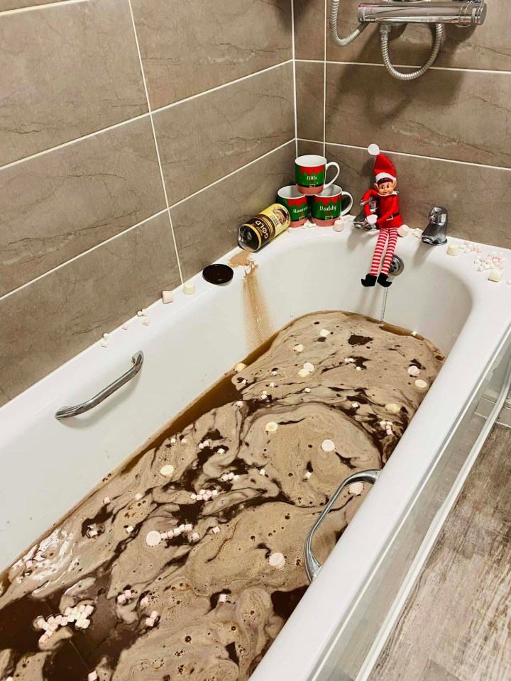 Elf on the Shelf in a bathtub of hot chocolate and marshmallows.