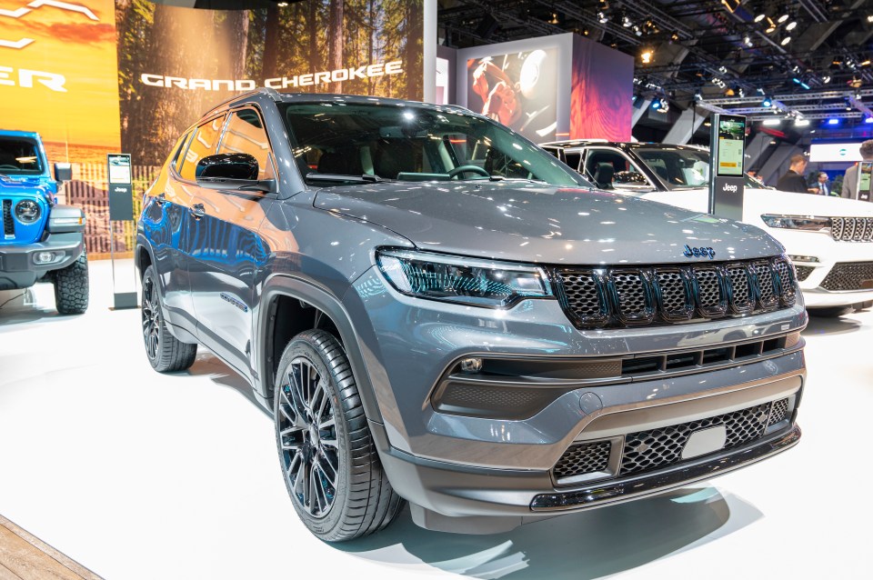 Gray Jeep Compass 4xe on display at a car show.