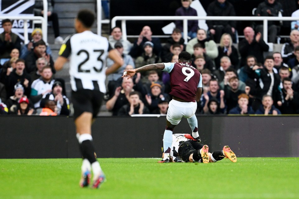 Jhon Duran of Aston Villa fouls a Newcastle United player, resulting in a red card.