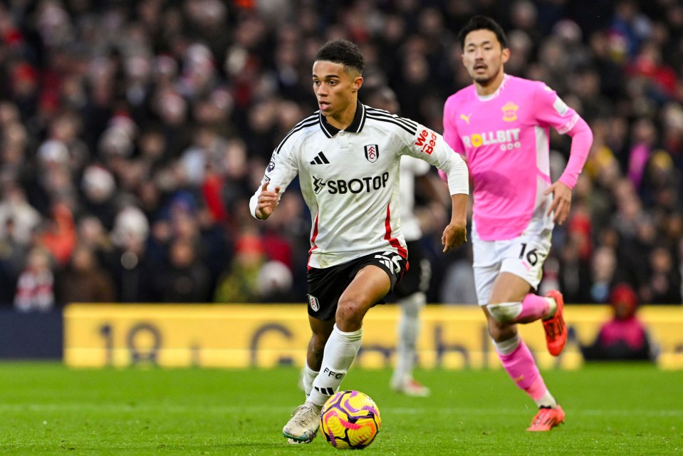 Josh King of Fulham FC dribbling the ball during a Premier League match.