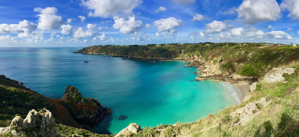 Guernsey coastline with turquoise water.