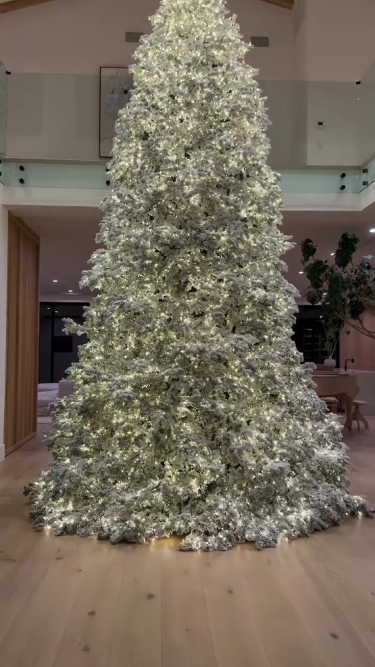 Kim’s home features an enormous, fully decorated white Christmas tree