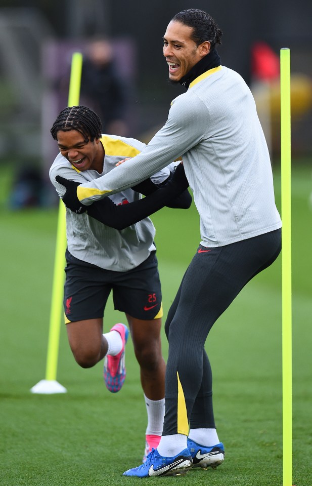 Liverpool's Virgil van Dijk and Rio Ngumoha playfully interacting during a training session.