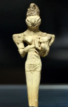 A 'lizard-headed' female figurine nursing a child dating to the Ubaid period