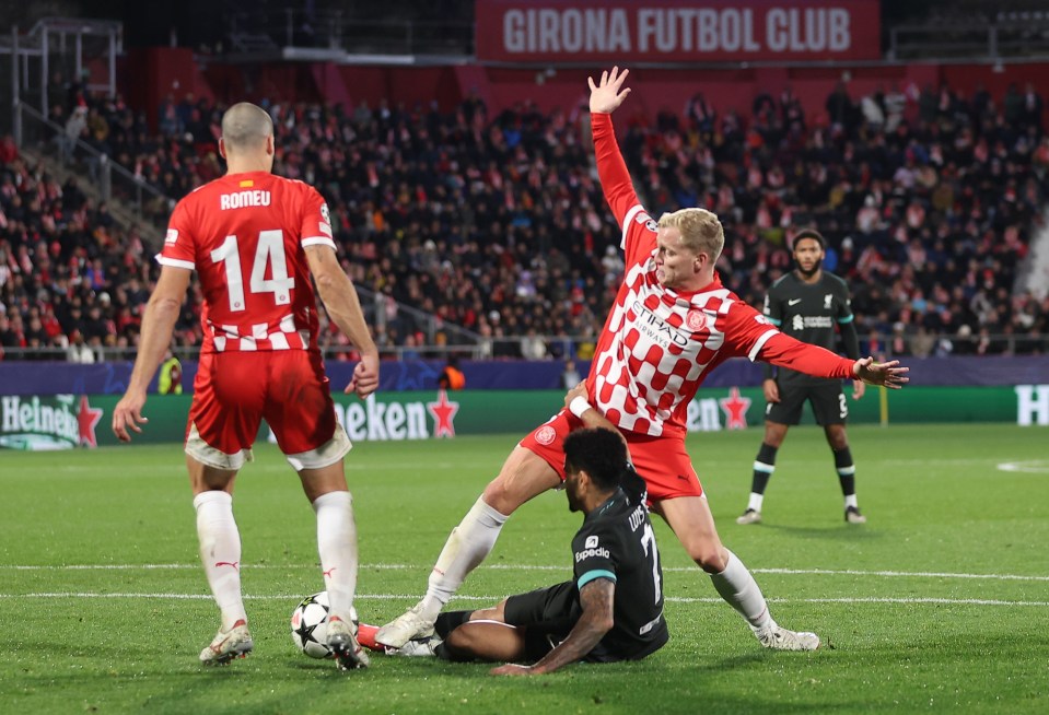 Luis Diaz of Liverpool is fouled by Donny van de Beek of Girona FC, resulting in a penalty kick.