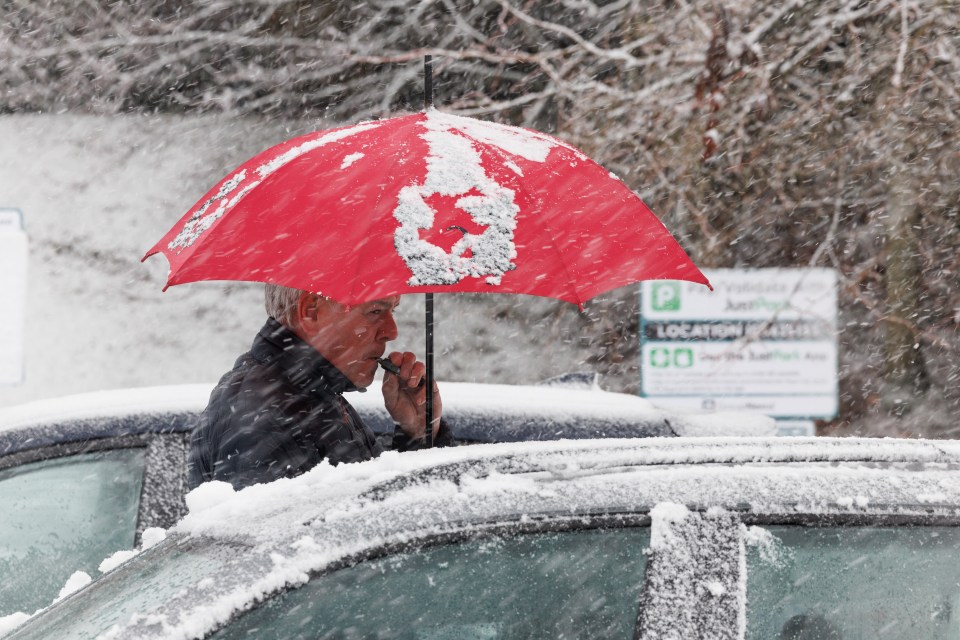 A man at the M9 motorway services near Stirling on November 23 after Storm Bert pummelled parts of the UK