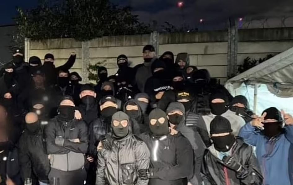 Group of masked individuals after a Manchester United vs FC Twente match.