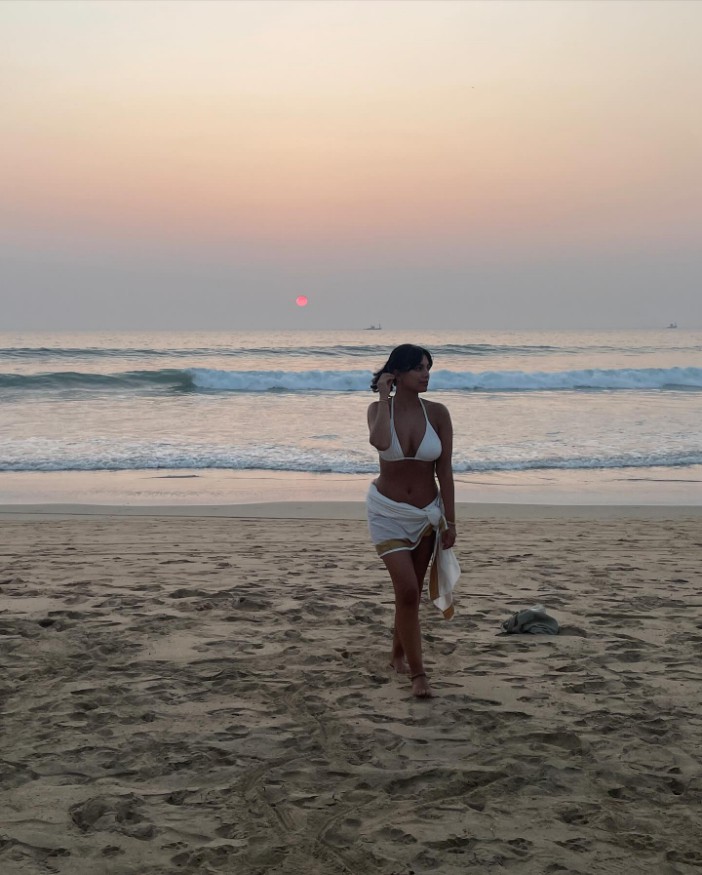 Fiona posed in a white bikini while posing against a backdrop of the sea