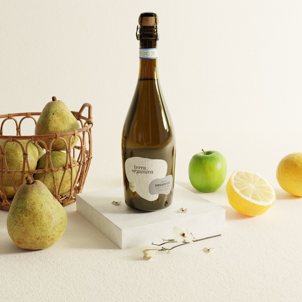 Bottle of Terra Organica Prosecco on a marble block with pears, apple, and lemon.