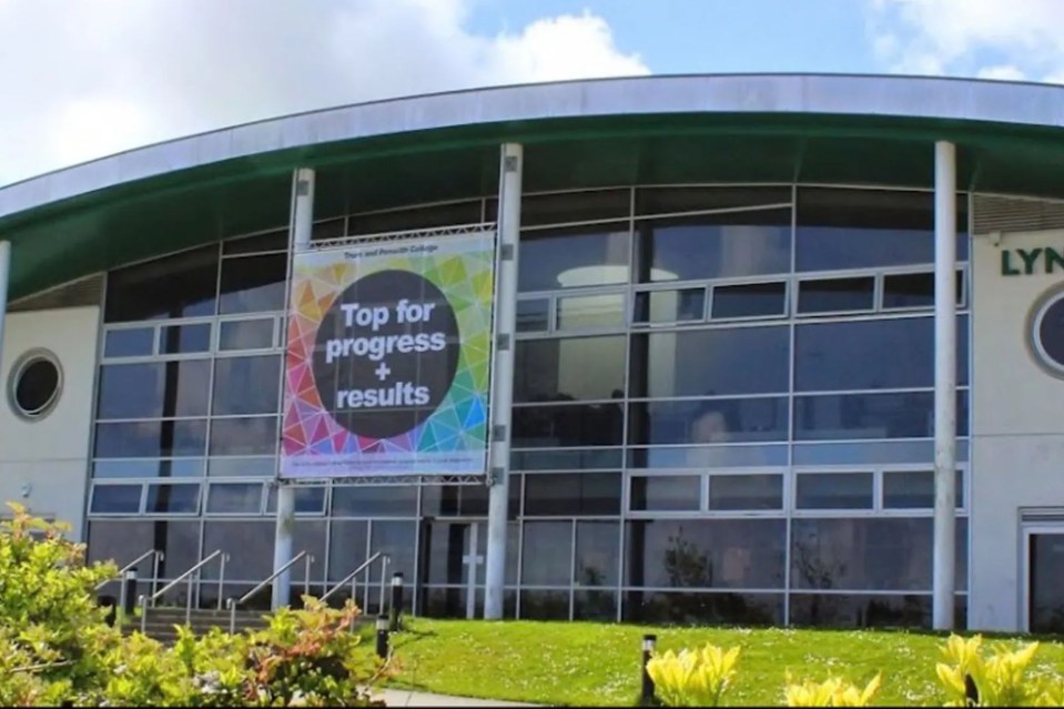 College building with a sign that says "Top for progress + results".