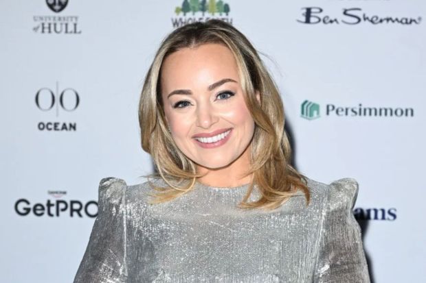 Woman in silver sequined dress at an event.