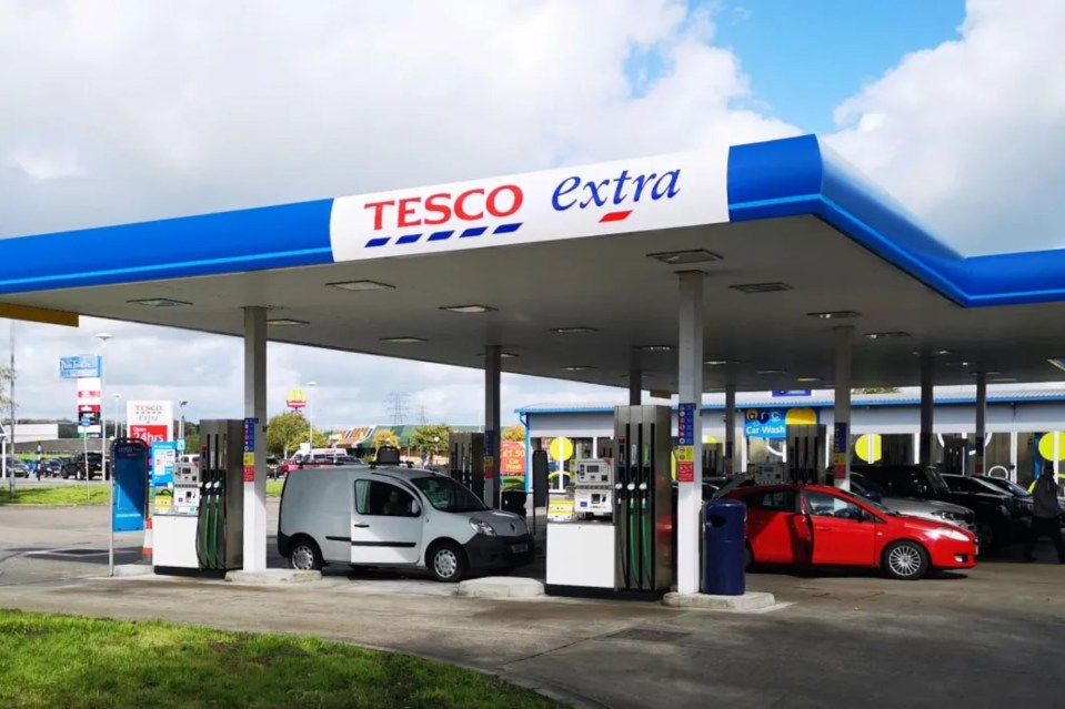 Tesco Extra petrol station with cars fueling.