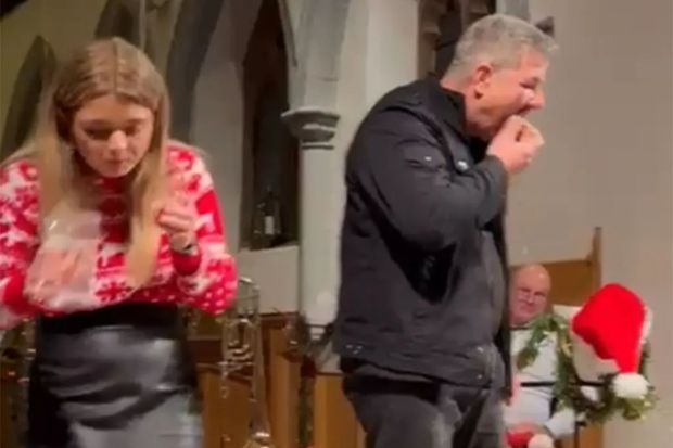 A man and woman eating in a church.