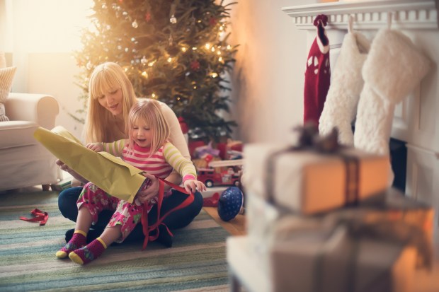 Mother and daughter opening Christmas presents.