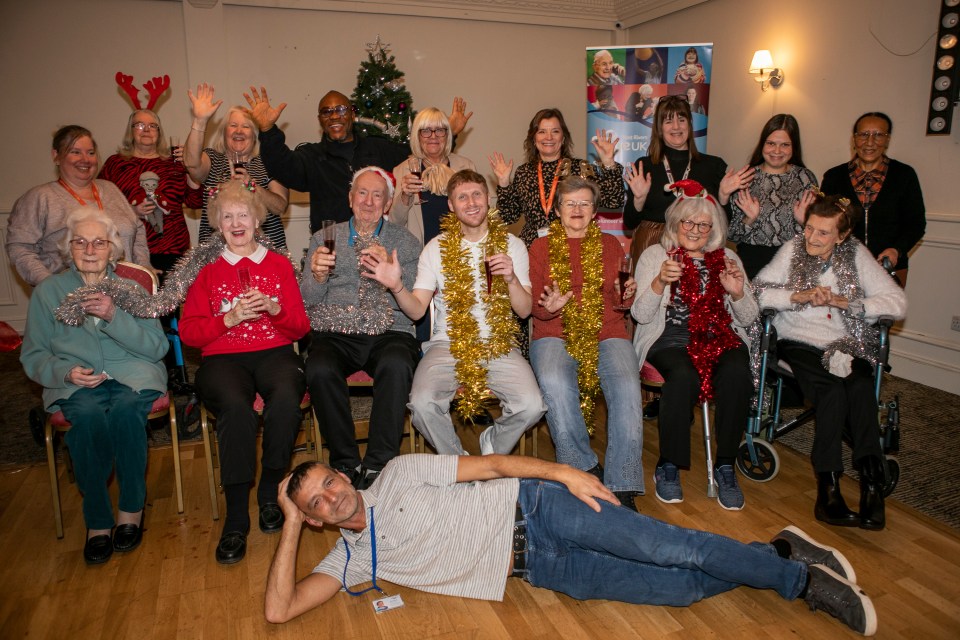 The day centre visitors celebrate with staff and Jamie