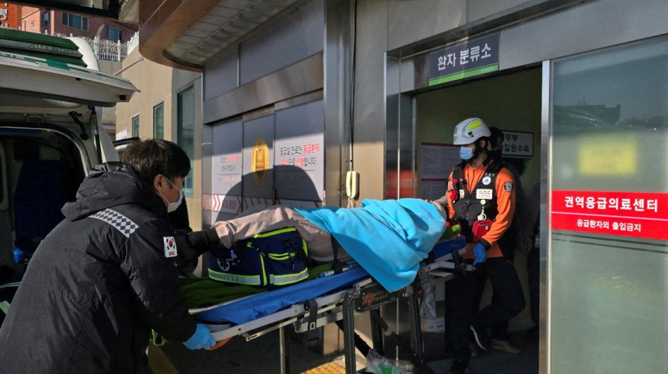 One of the survivors of the disaster being taken to hospital