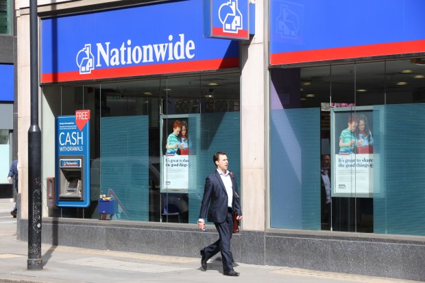 A man walks past a Nationwide Building Society branch in London.