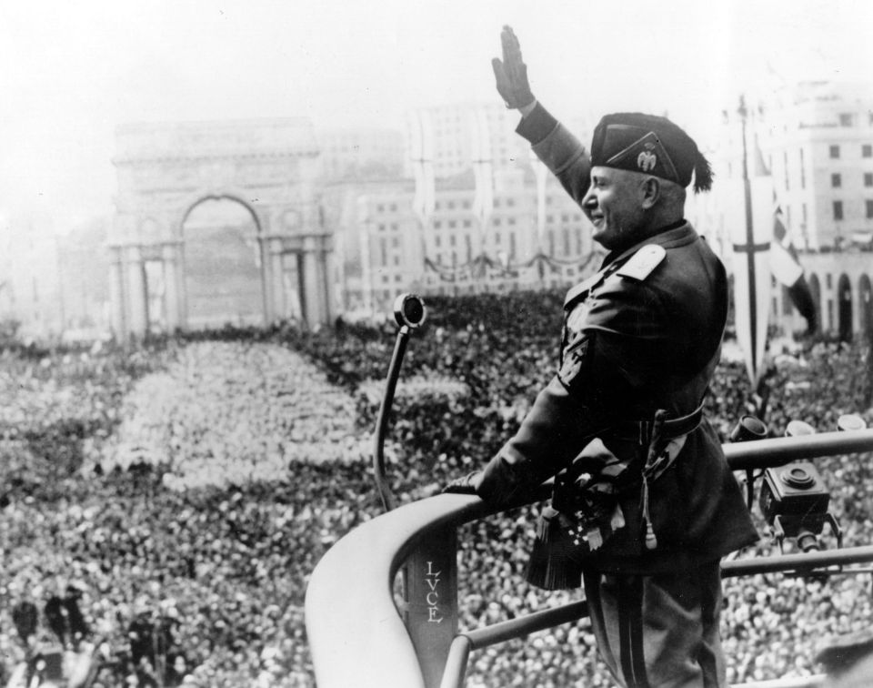 Benito Mussolini salutes the crowd during his tyrannical rule