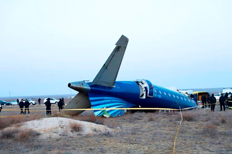 An Azerbaijan Airlines Embraer 190 plane lies on its side near the Aktau airport after an accident.