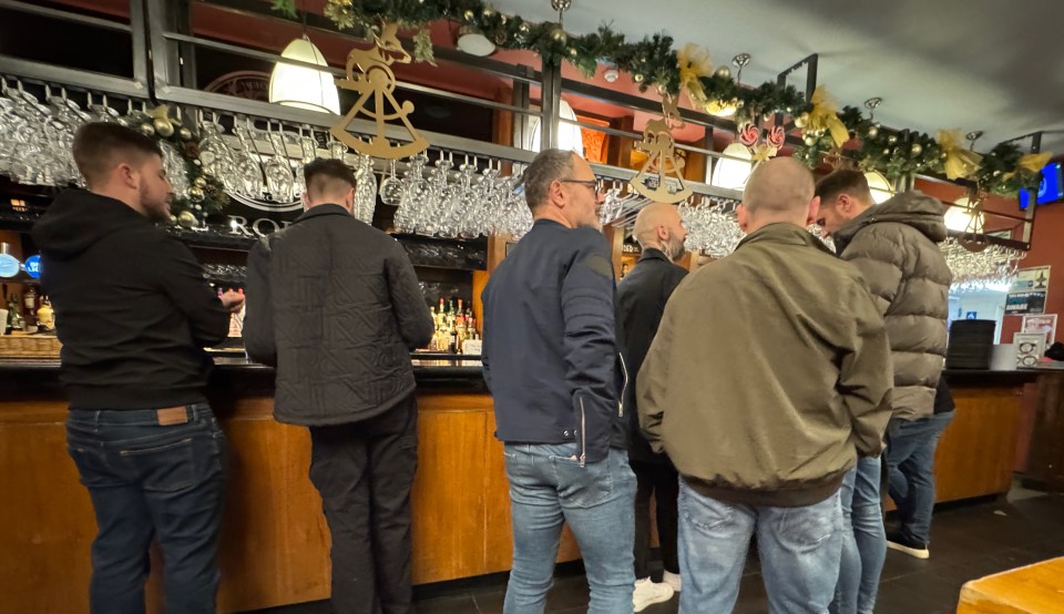 Customers ordering drinks at the bar at the Roebuck pub in Rayleigh, Essex