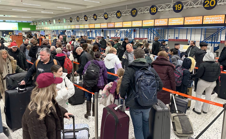 Long queue of passengers at Manchester Airport during the Christmas getaway.