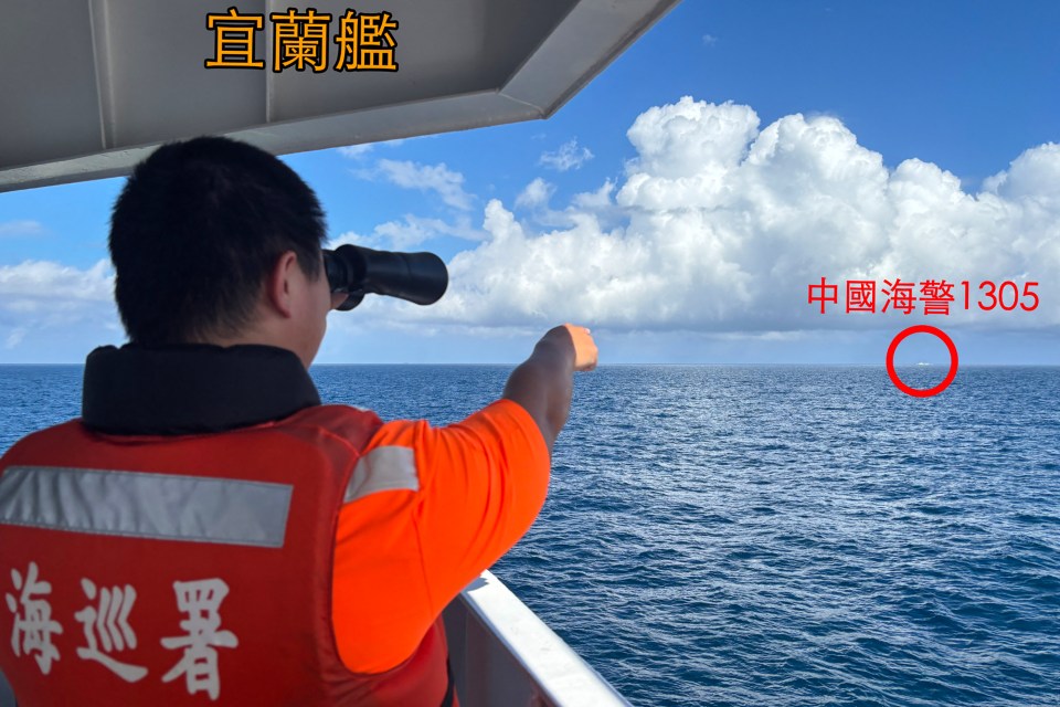 Taiwan Coast Guard personnel spots a Chinese Coast Guard ship sailing in the distance outside Taiwan’s territorial waters