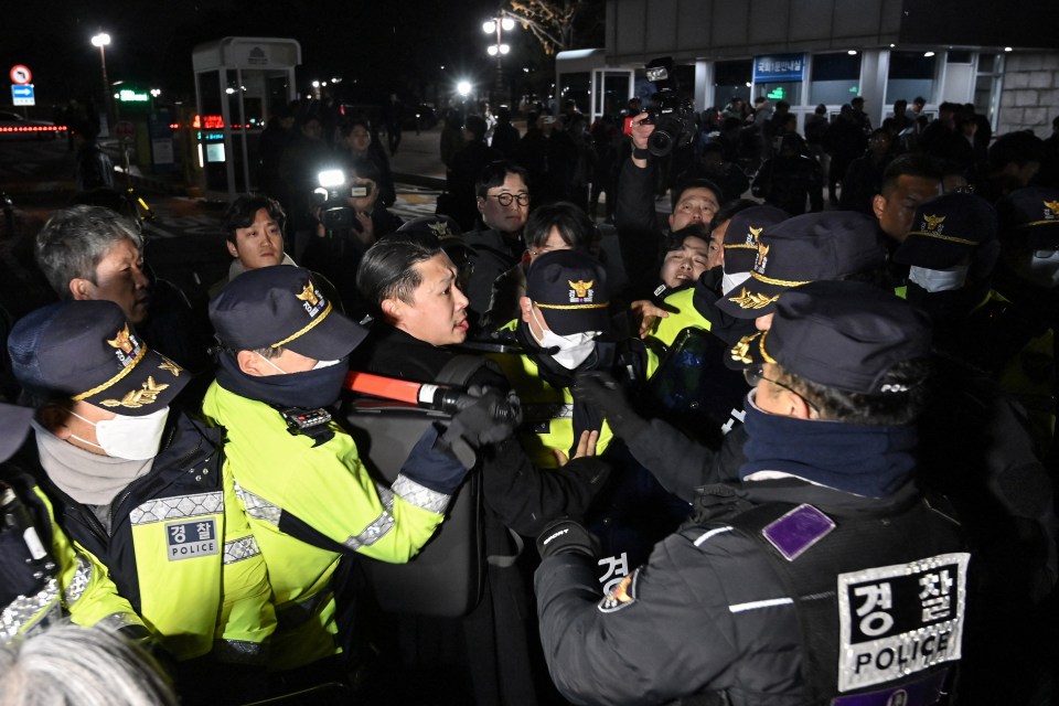 Police attempt to hold back people trying to enter the National Assembly on 3 December